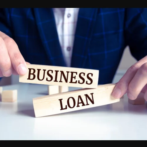 Business owner arranging business loan blocks, representing startup financing, small business funding, and entrepreneurial loan solutions.