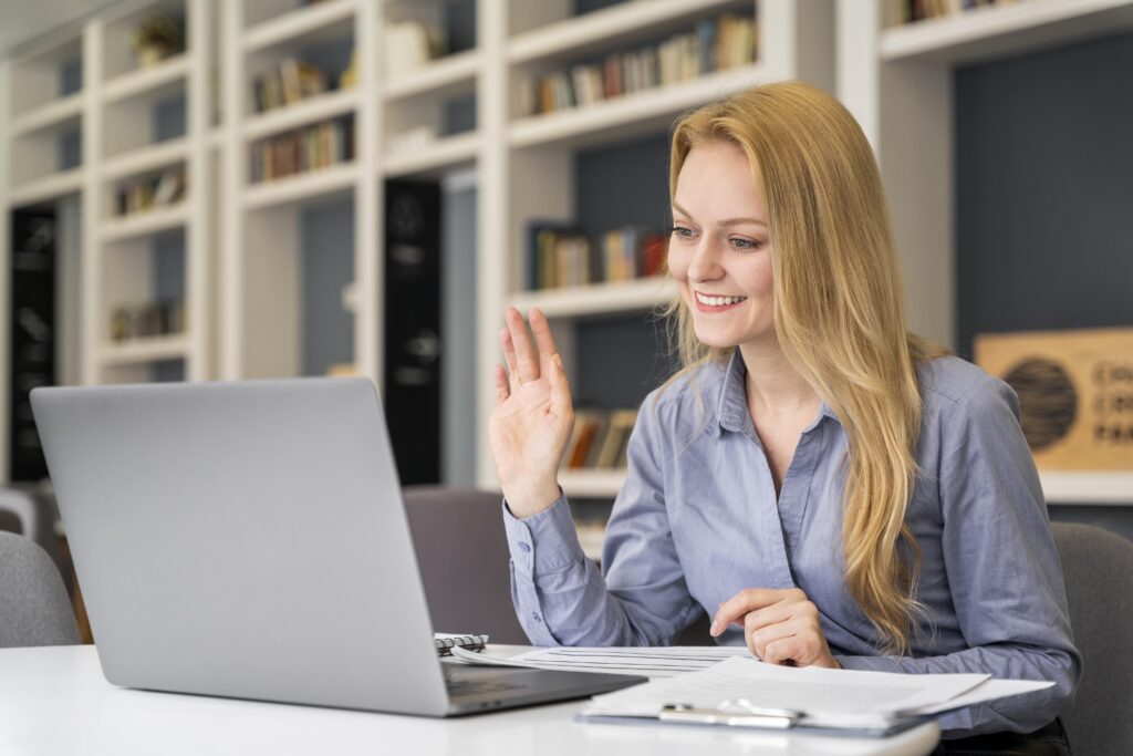 Professional woman attending a virtual meeting on a laptop from her home office, representing a successful home-based online business in the United States.