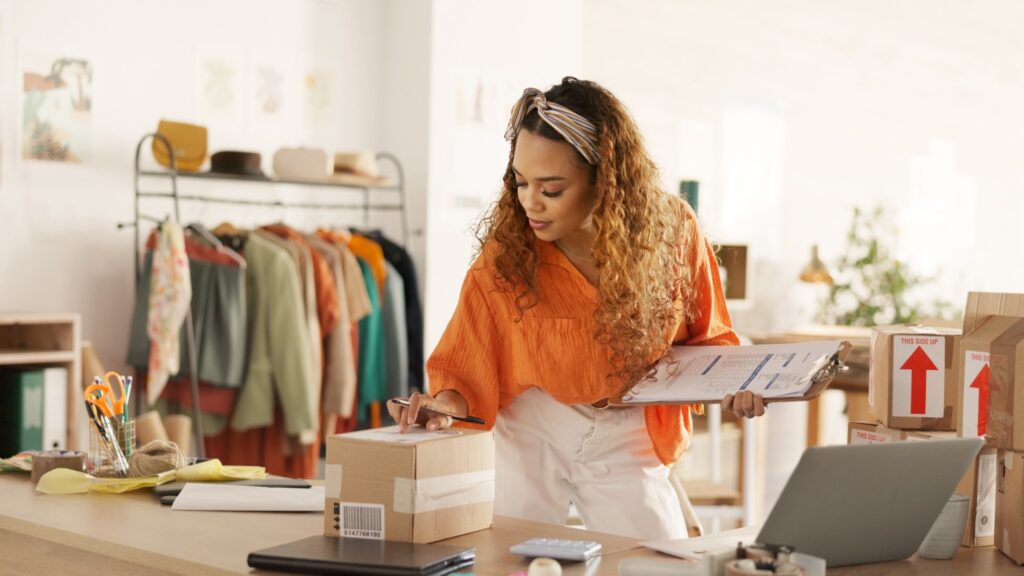 Woman packaging customer orders in a home-based online business, managing inventory and shipping products for a profitable eCommerce startup in 2026.