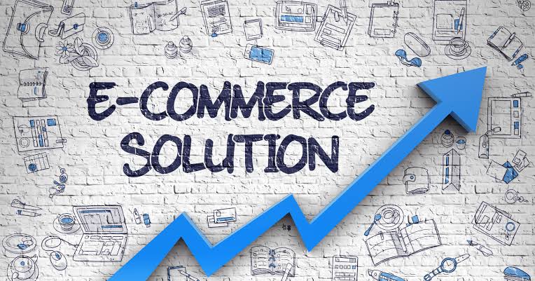 E-commerce solution concept with a blue upward growth arrow on a business planning background. 