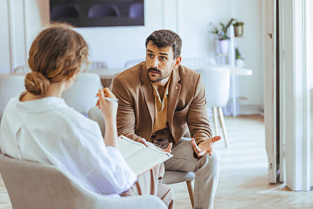 A life coach having a one-on-one consultation with a client in a professional setting.