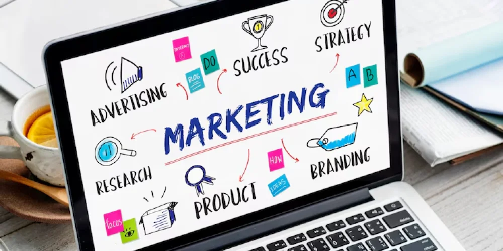 Marketing strategy concept displayed on a laptop screen with advertising, research, branding, product, and business success elements. 