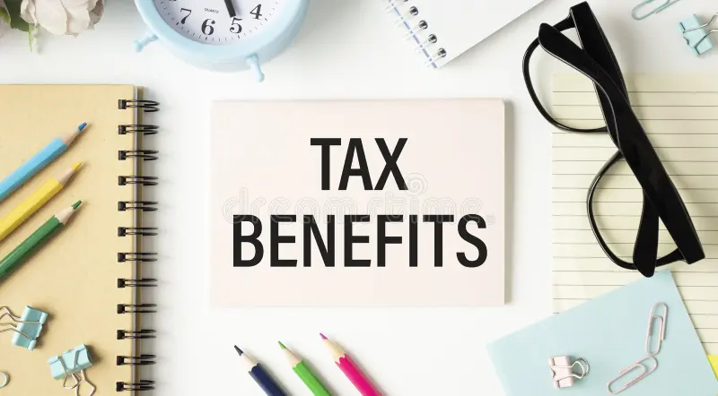 Tax Benefits for Small Businesses featuring a tax benefits document surrounded by business planning and accounting supplies.