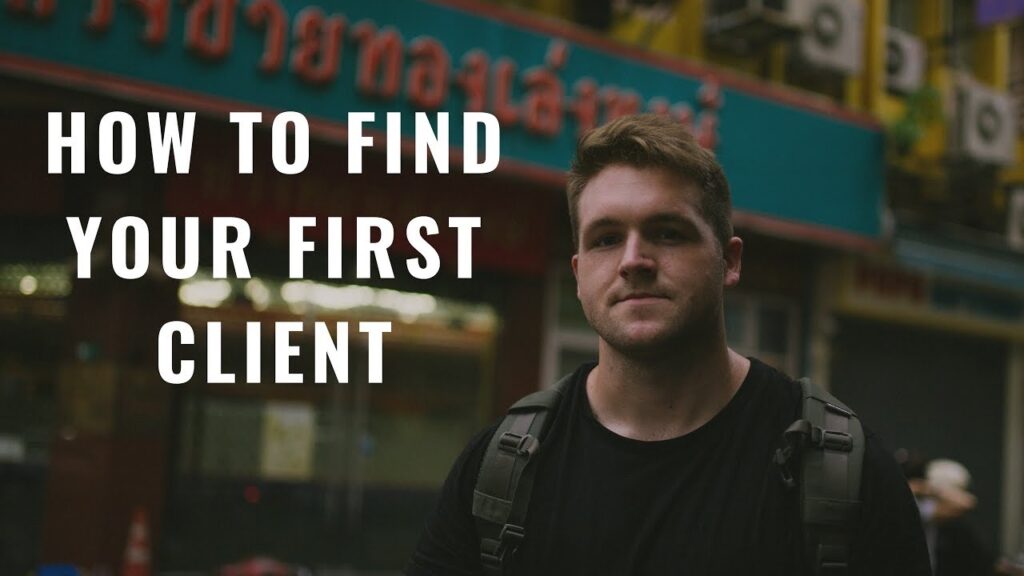 Young man with short brown hair and a black t-shirt wearing a backpack, standing on a blurred city street, with the text "How to Find Your First Client" overlaid on the left.